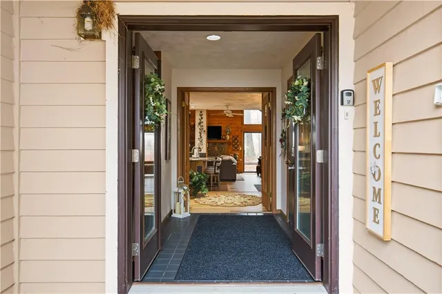 a view of a hallway with wooden floor and a living room