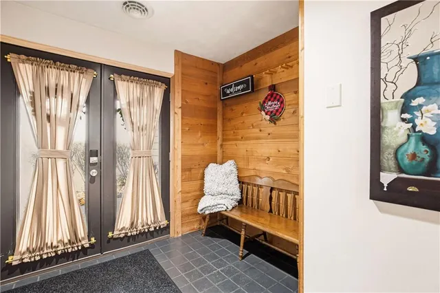 a view of entryway with wooden floor and furniture