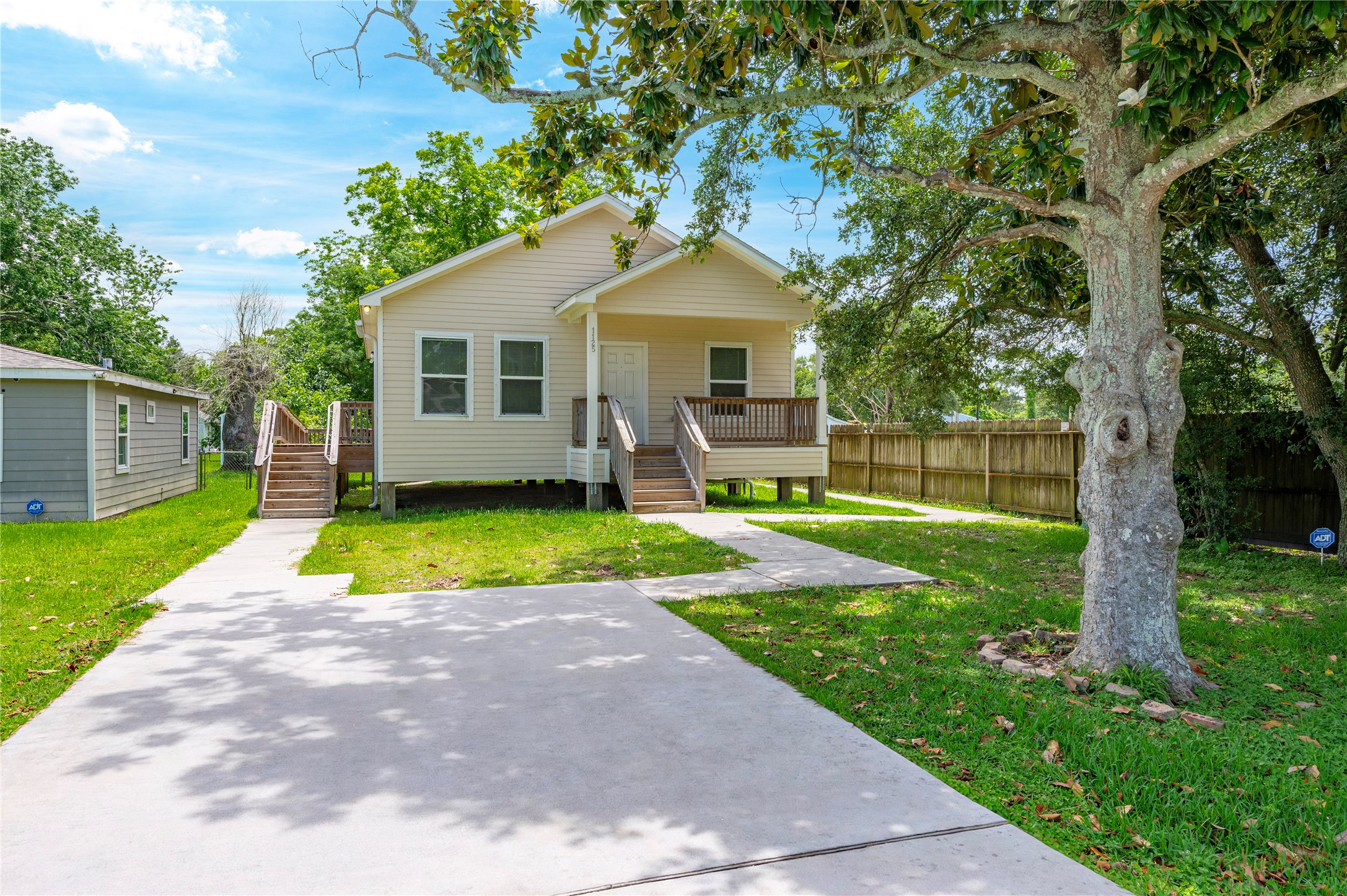a view of a house with a yard and sitting area
