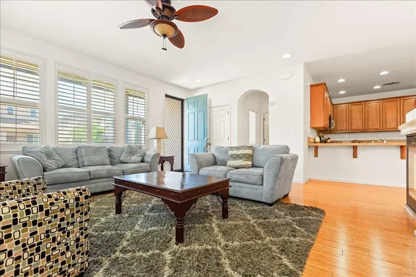 a kitchen with granite countertop a refrigerator stove top oven and sink