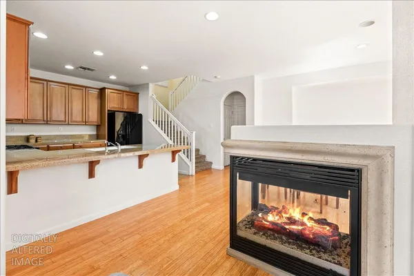 a kitchen with stainless steel appliances granite countertop a stove a sink dishwasher and a refrigerator