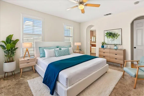 a bed sitting in a bedroom next to a window