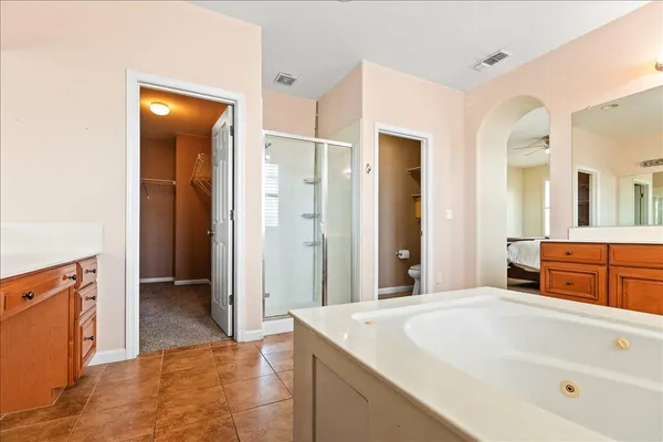 a white toilet sitting next to a bath tub and a shower