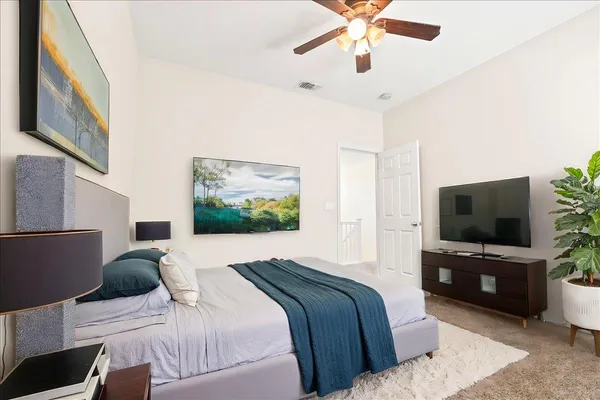 a bedroom with a bed and wooden floor
