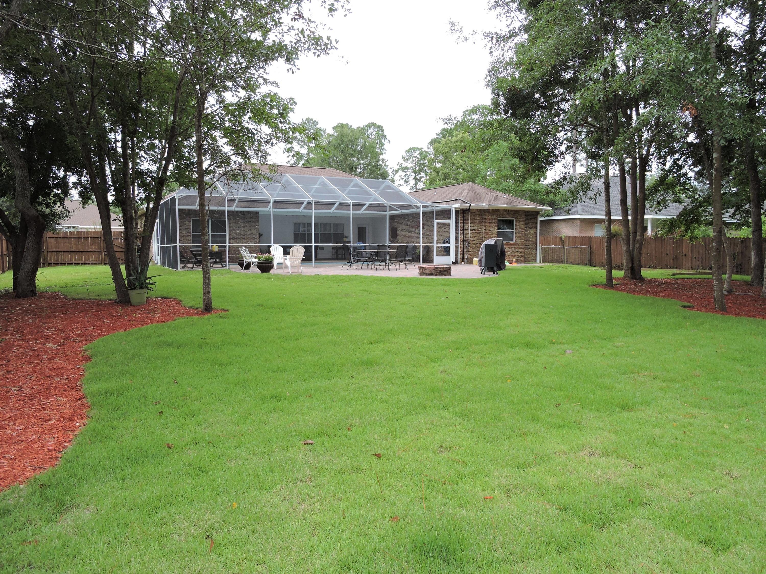 4458 Kingslynn Road Niceville, FL 32578 - Photo 3 of 37 a view of a big yard next to a house