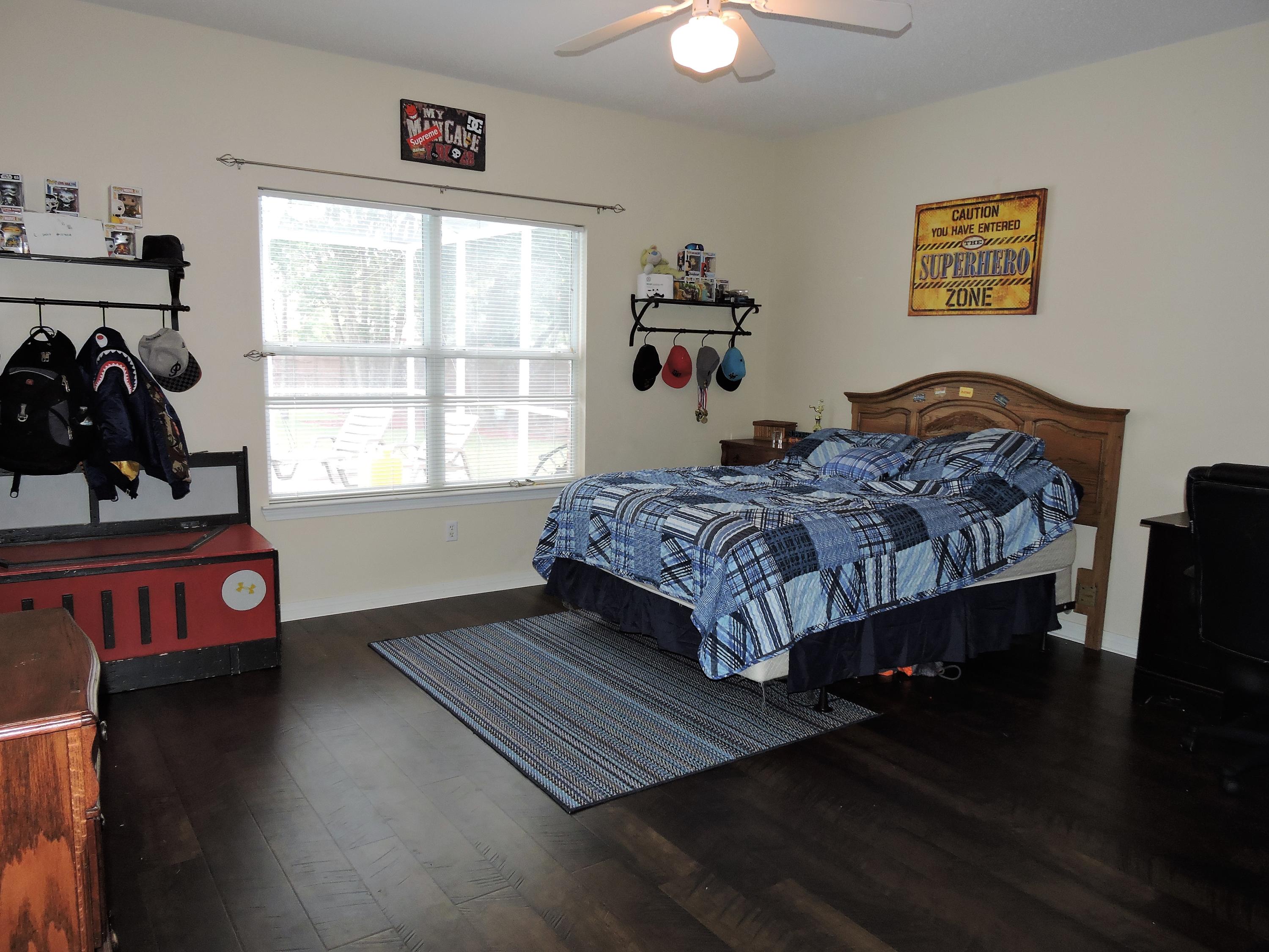 4458 Kingslynn Road Niceville, FL 32578 - Photo 22 of 37 a bedroom with a bed and a window