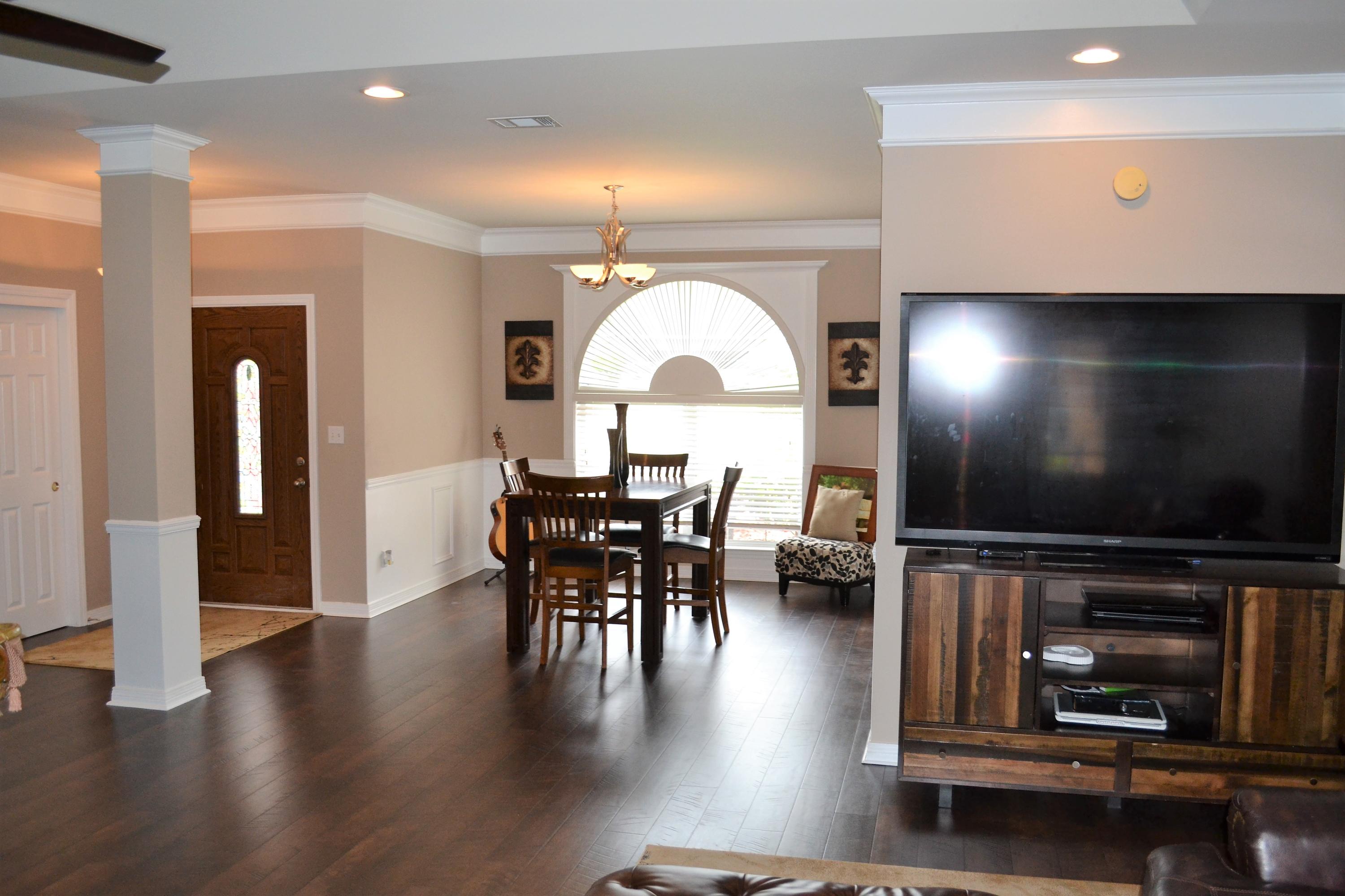 4458 Kingslynn Road Niceville, FL 32578 - Photo 4 of 37 a view of a dining room with furniture and wooden floor