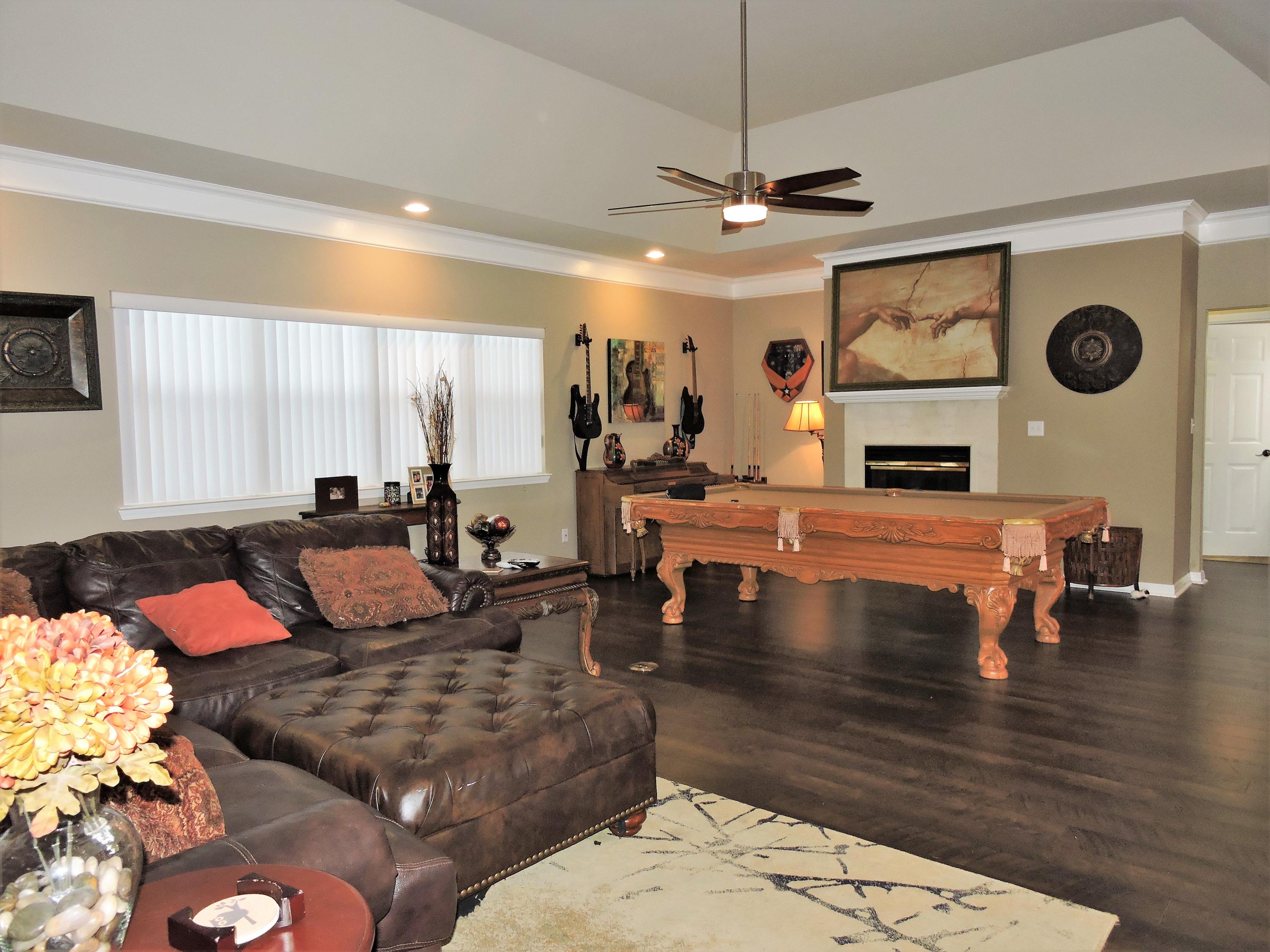 4458 Kingslynn Road Niceville, FL 32578 - Photo 5 of 37 a living room with fireplace furniture and a large window