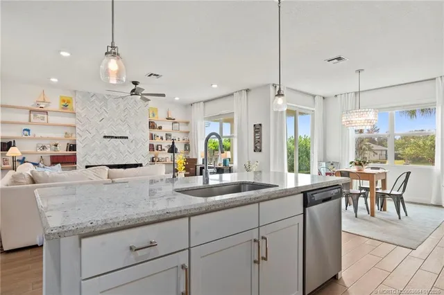 a kitchen with counter top space appliances and a large window