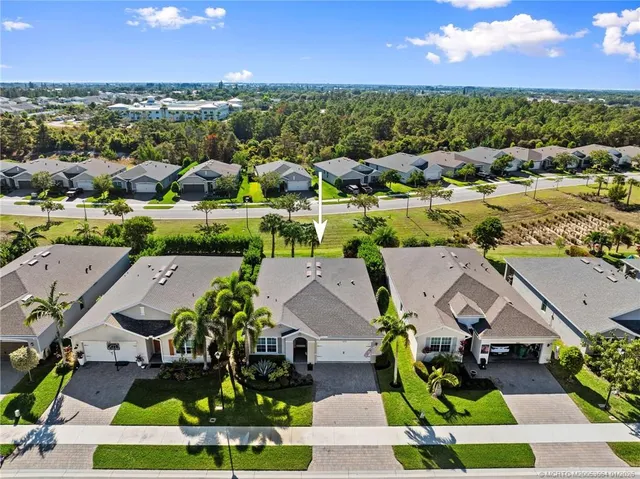 an aerial view of residential houses with outdoor space and ocean view