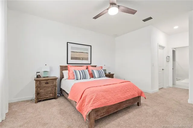 a bedroom with a bed and ceiling fan