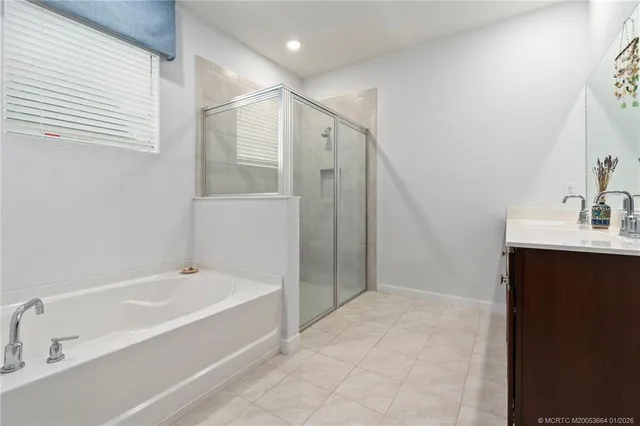 a spacious bathroom with a bathtub and a sink