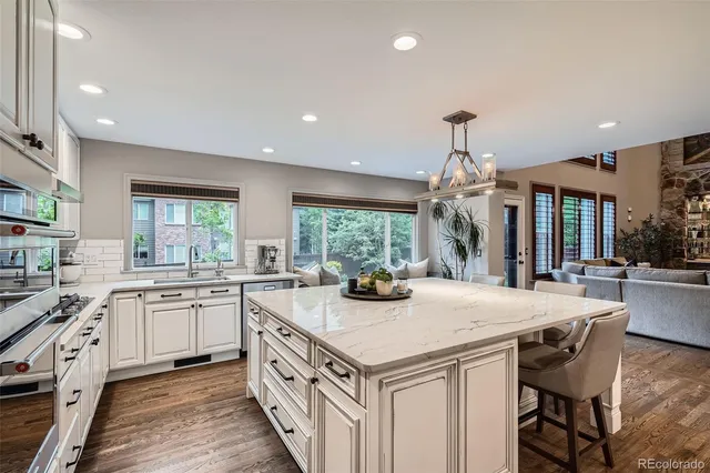 a kitchen with granite countertop a sink and cabinets