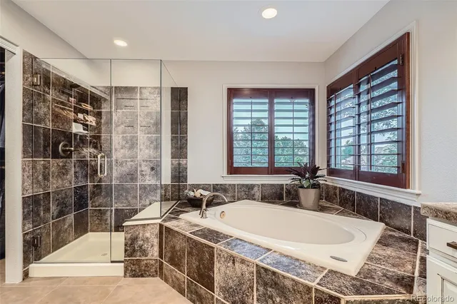 a bath tub sitting next to a blue sink and shower