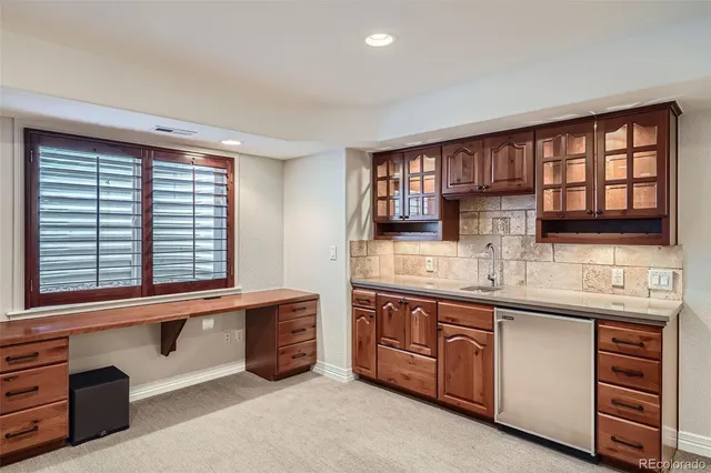 a kitchen with stainless steel appliances granite countertop a sink and a window