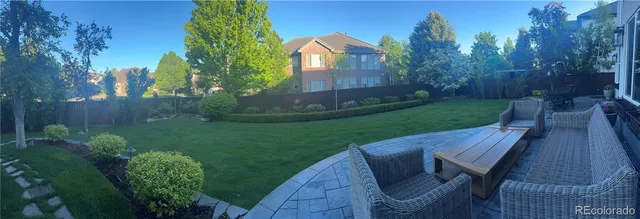 a view of a wooden chairs in backyard of the house
