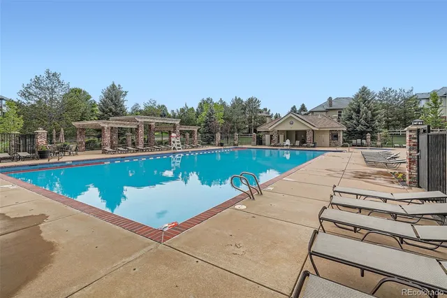a view of a swimming pool with a lounge chair