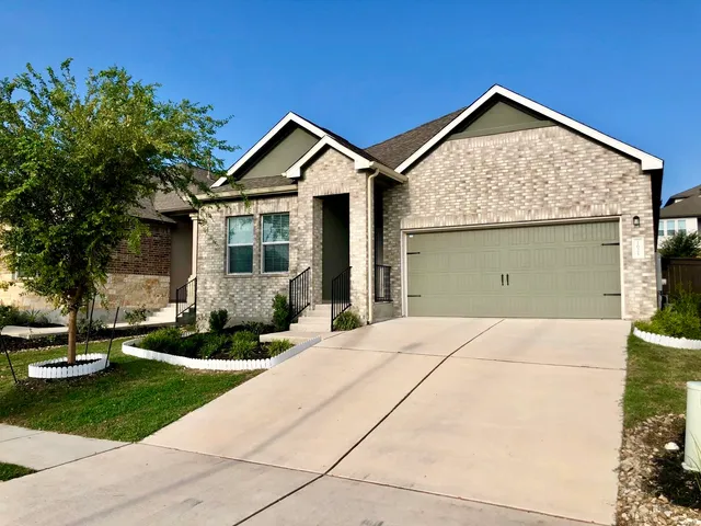 a front view of a house with a yard and porch