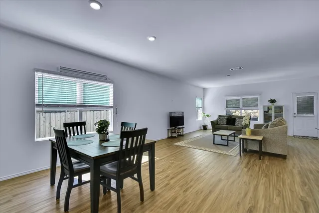 a view of a dining room with furniture window and wooden floor