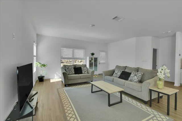 a living room with furniture and a rug