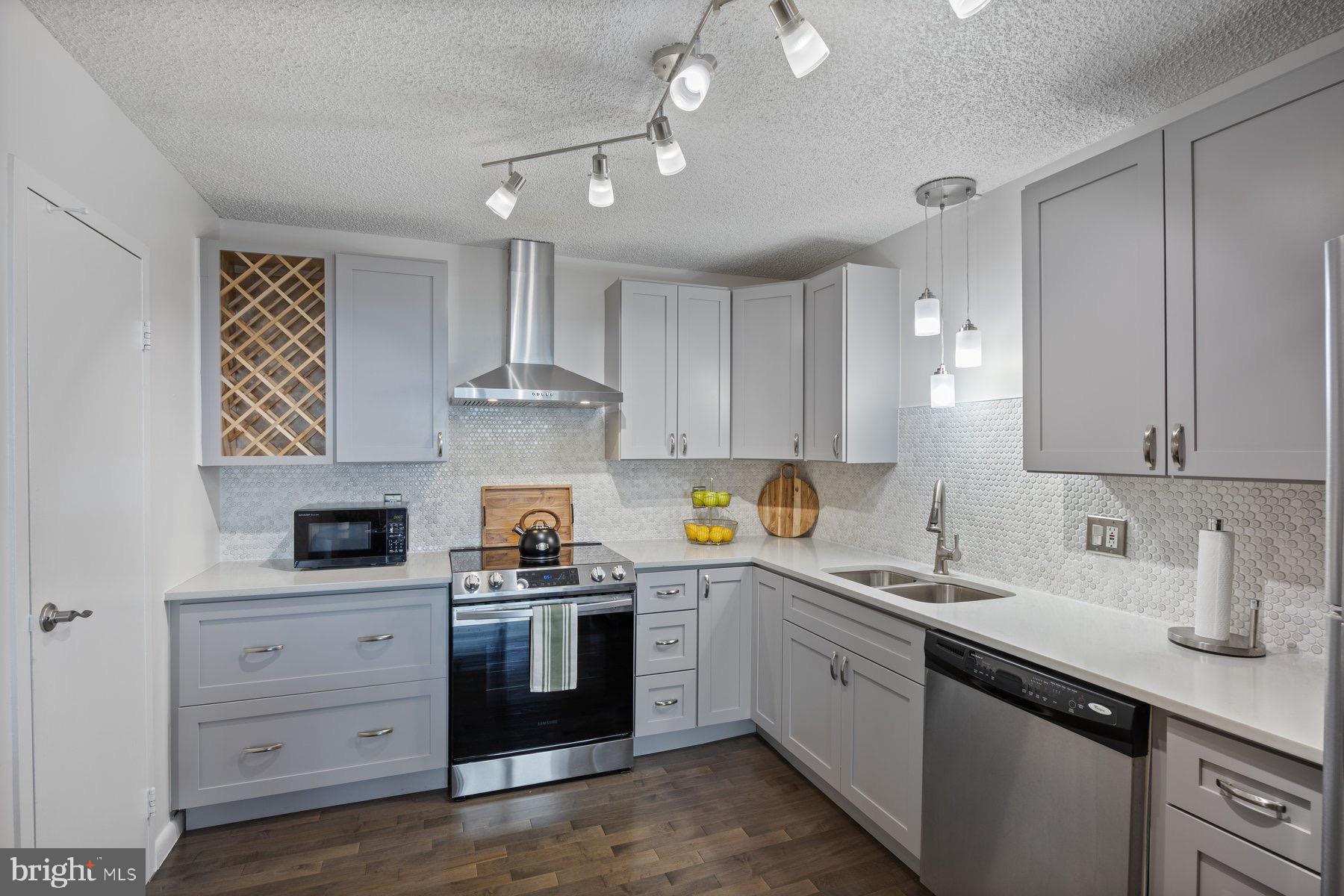 205 East Joppa Road, Unit 2403 Towson, MD 21286 - Photo 14 of 48 a kitchen with white cabinets stainless steel appliances and sink