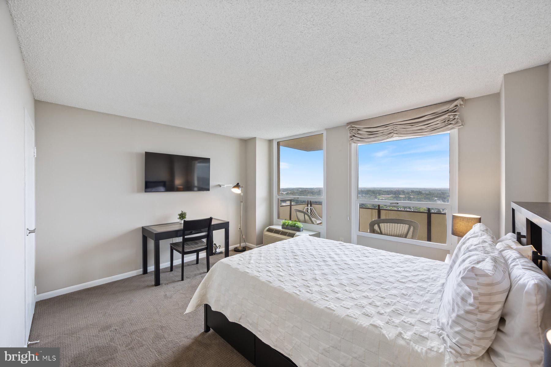 205 East Joppa Road, Unit 2403 Towson, MD 21286 - Photo 17 of 48 a bedroom with a bed and a flat screen tv