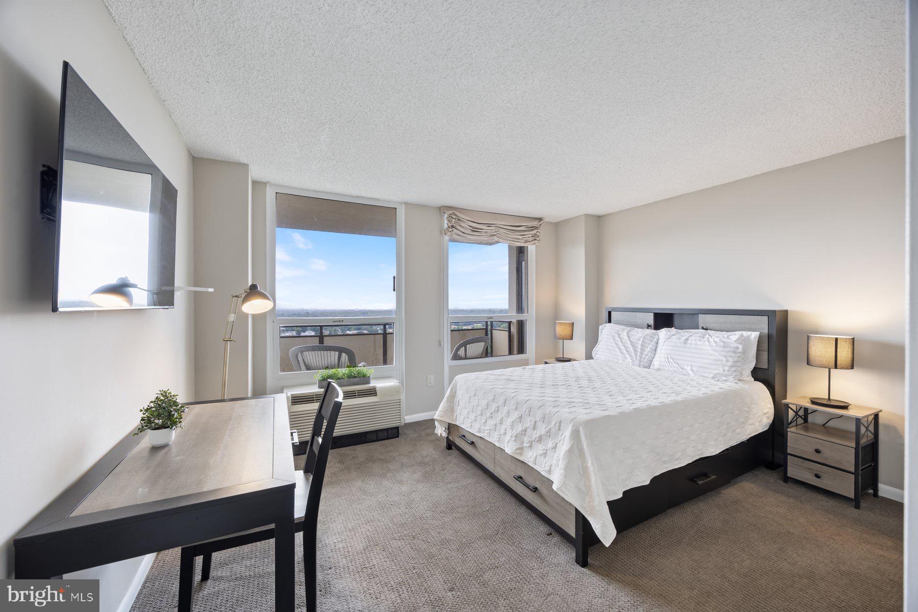 205 East Joppa Road, Unit 2403 Towson, MD 21286 - Photo 19 of 48 a bedroom with a bed a desk and chair