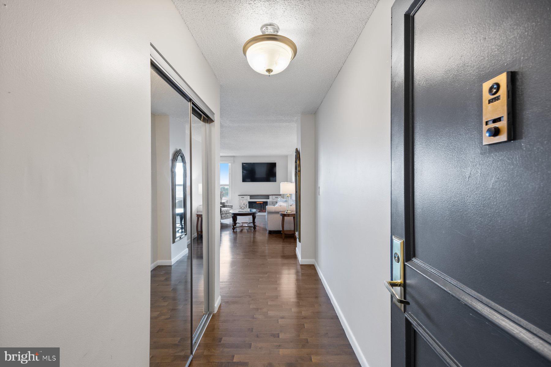 205 East Joppa Road, Unit 2403 Towson, MD 21286 - Photo 2 of 48 a view of a hallway with wooden floor and furniture