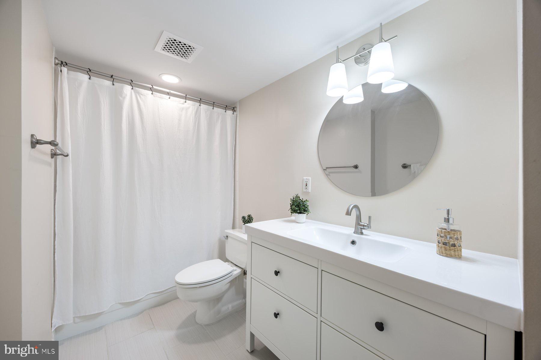 205 East Joppa Road, Unit 2403 Towson, MD 21286 - Photo 20 of 48 a bathroom with a sink a toilet and a mirror