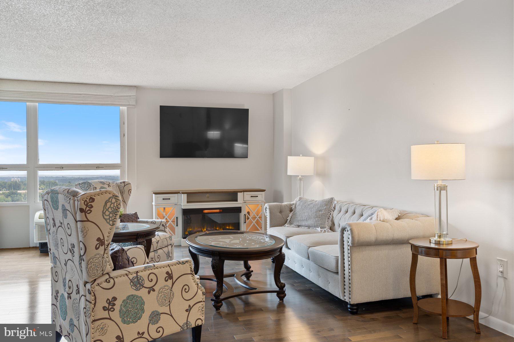 205 East Joppa Road, Unit 2403 Towson, MD 21286 - Photo 5 of 48 a living room with furniture a flat screen tv and a lamp