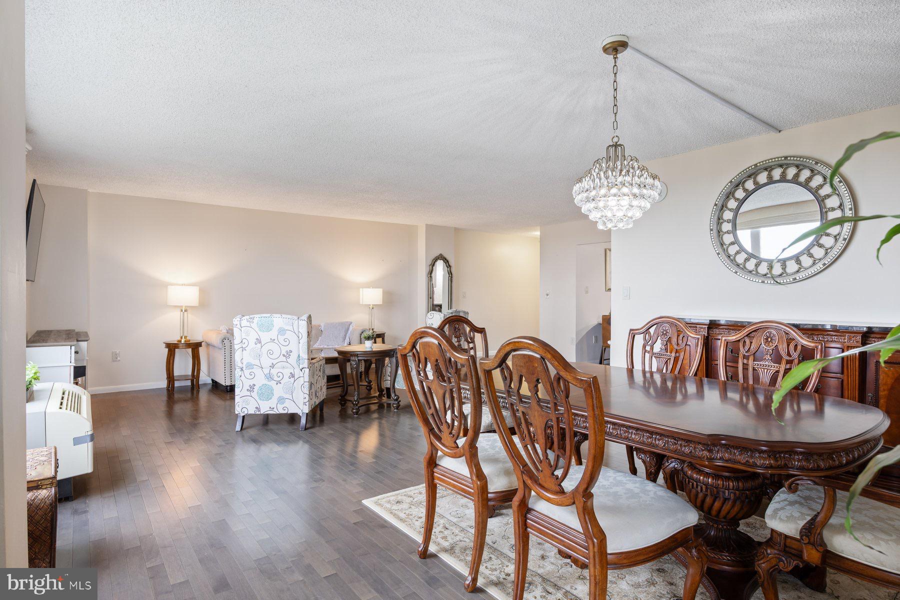 205 East Joppa Road, Unit 2403 Towson, MD 21286 - Photo 6 of 48 a view of a dining room with furniture chandelier and wooden floor