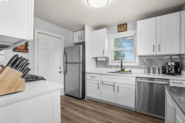 a kitchen with a refrigerator and a sink