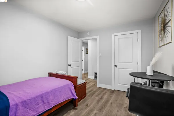 a bedroom with a bed a desk and chair