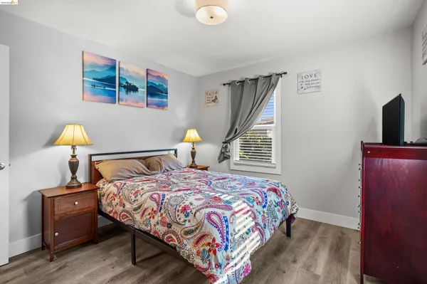 a bedroom with a bed and a lamp on the table