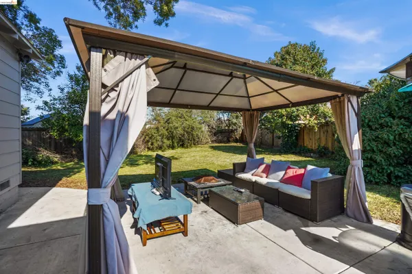 an outdoor sitting area with furniture and garden view