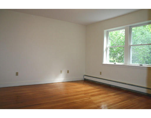 9 E Road Wayland, MA 01778 - Photo 18 of 21 a view of an empty room with wooden floor and a window