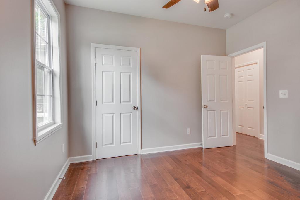 245 Manzano Road Madison, TN 37115 - Photo 10 of 17 an empty room with wooden floor and windows