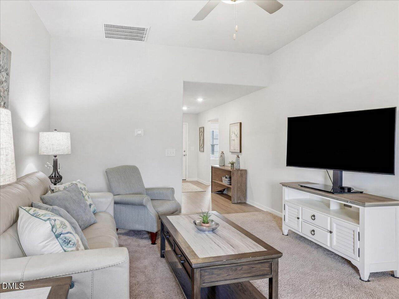 90 Barnsley Road Angier, NC 27501 - Photo 10 of 40 a living room with furniture and a flat screen tv