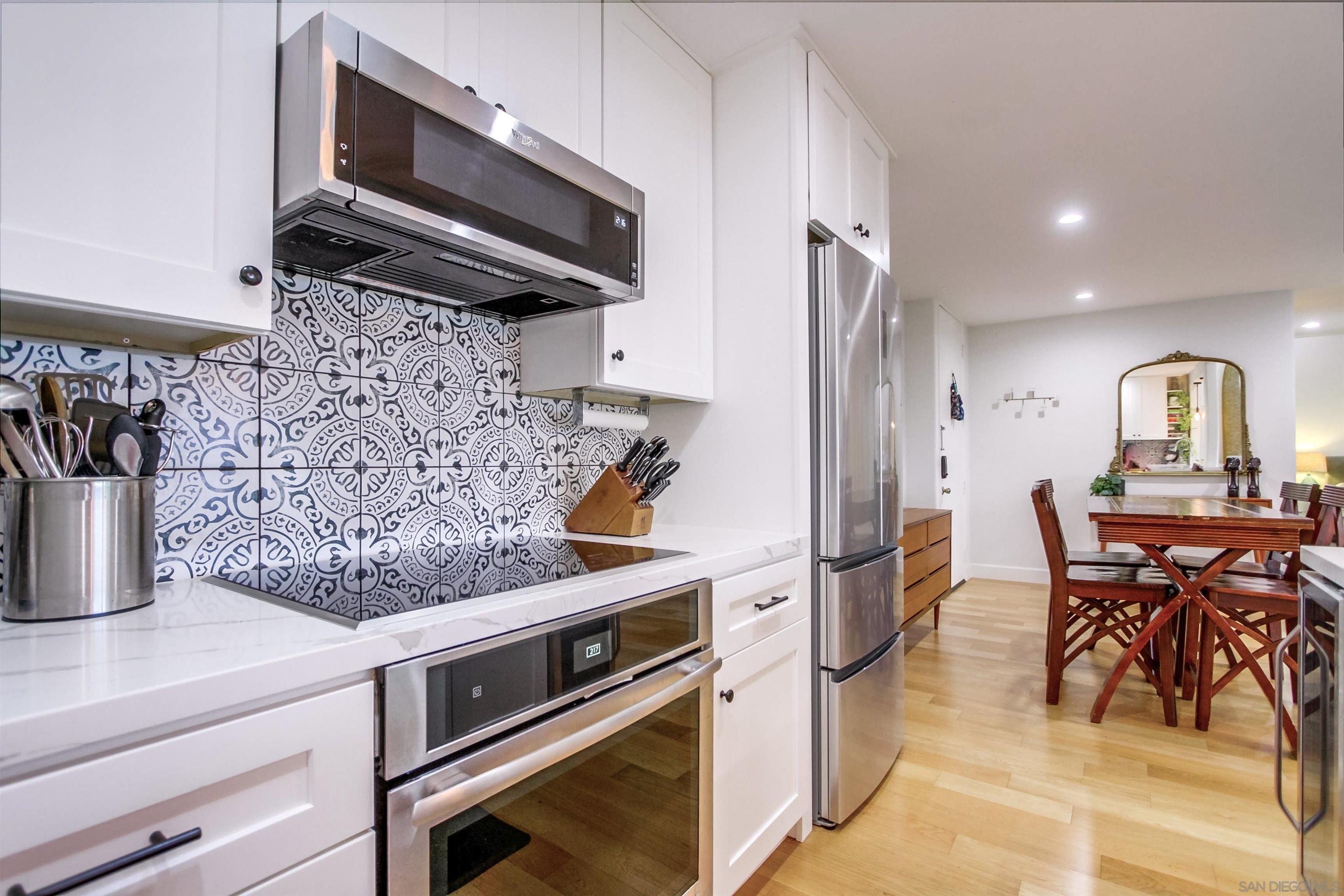 a kitchen with stainless steel appliances granite countertop a stove and a microwave
