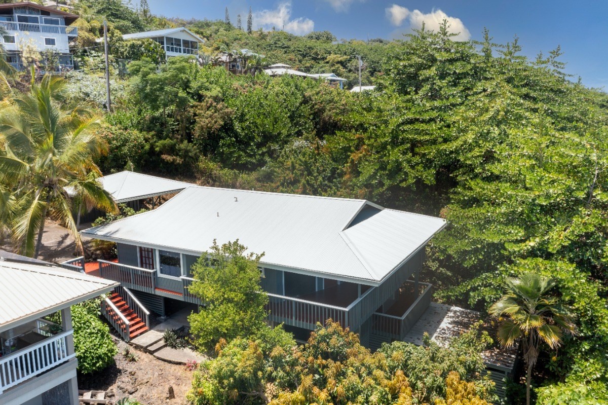 an aerial view of a house with yard and outdoor seating
