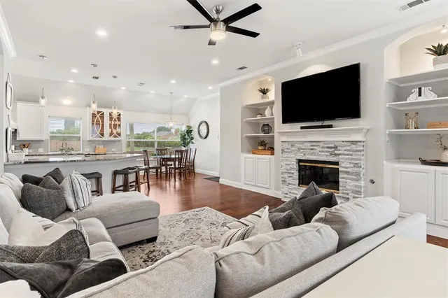 a living room with fireplace furniture and a flat screen tv