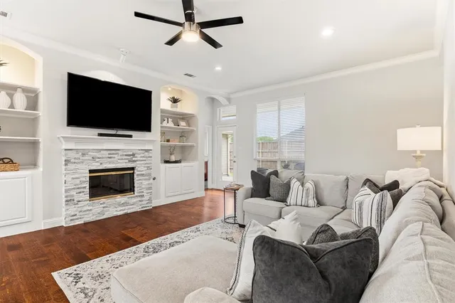 a living room with furniture a flat screen tv and a fireplace