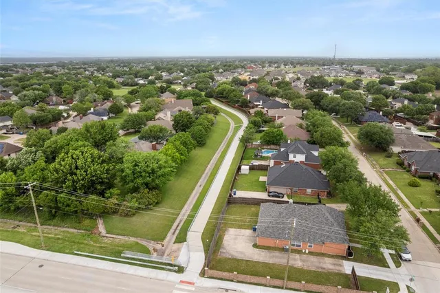 an aerial view of residential houses with outdoor space and river