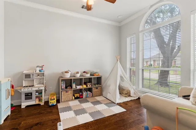 a living room with furniture and a floor to ceiling window