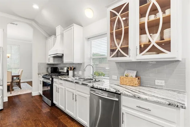 a kitchen with a sink a stove and cabinets