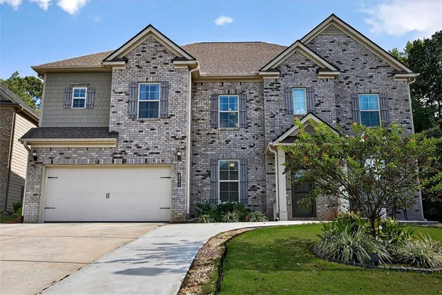 a front view of a house with a garden