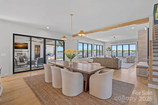 a living room with furniture large window and a table