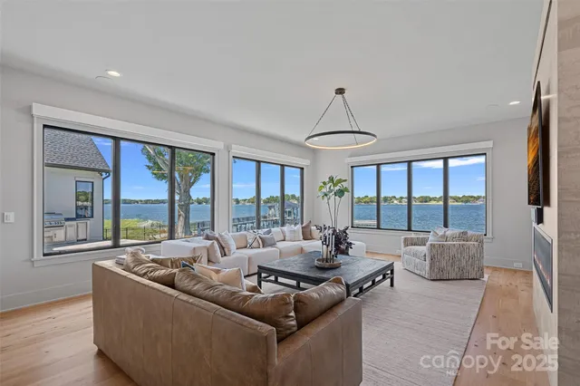a living room with furniture and large windows
