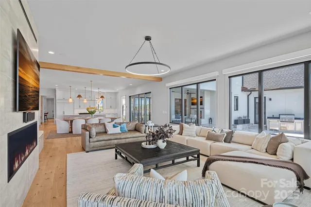 a living room with furniture and a chandelier