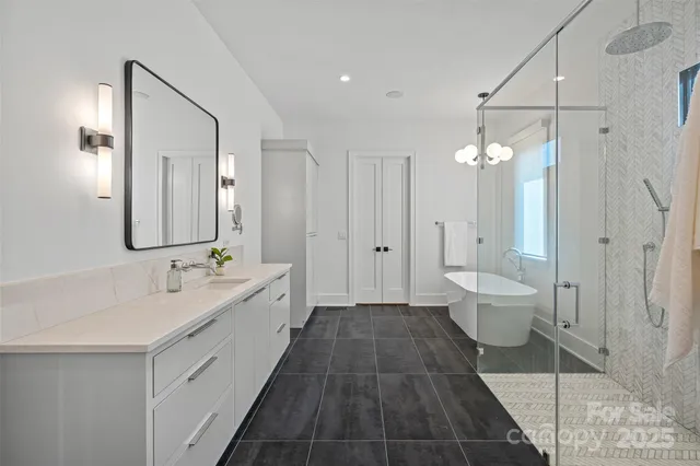 a spacious bathroom with a double vanity sink toilet and shower